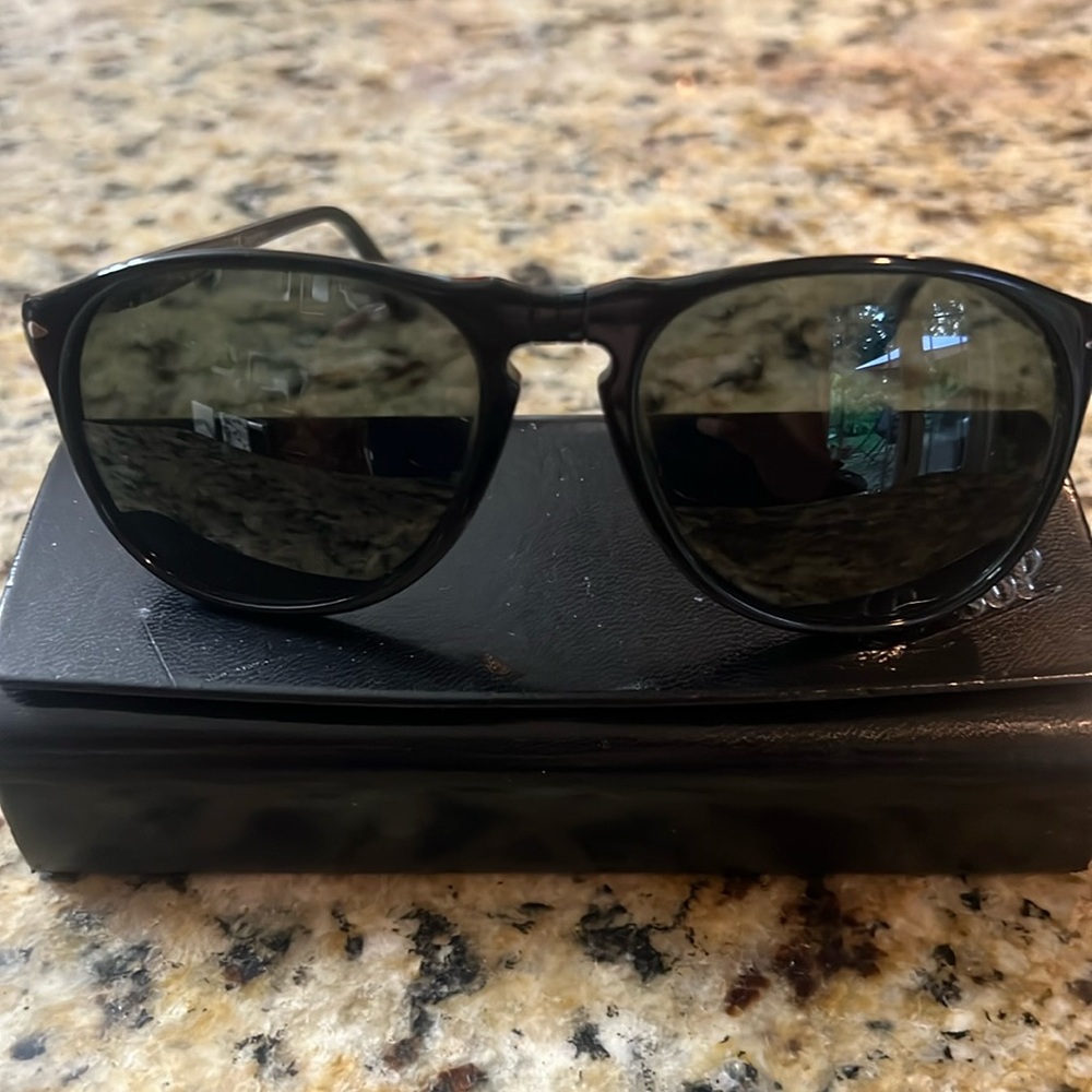 Unisex  Persol sunglasses with shiny Black frame and Silver hardware.